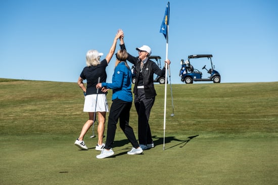 Image of Women Golfers High Fiving